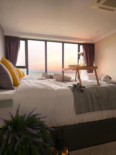 a large bed in a room with a large window at NEW Sunrise Gurney with SEAVIEW 无敌日出海景 in George Town