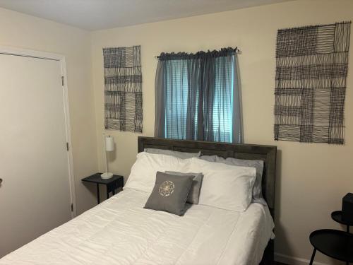 a bedroom with a white bed with a pillow on it at Atlanta Cozy Private Room 4 in Atlanta