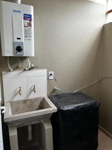 a bathroom with a sink and a trash can at Alquiler Temporario Perico 1 in Perico