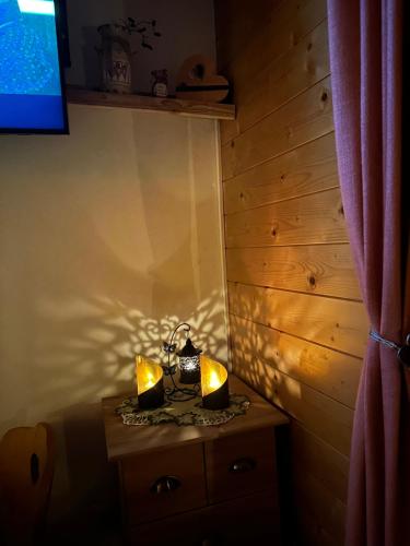 a room with a table with two candles on it at Almhaus Zirbenheim Nicolina in Flattnitz