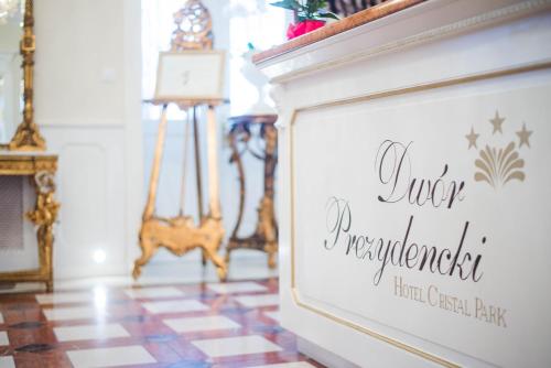 a sign on a wall in a room at Dwór Prezydencki Boutique Hotel & SPA in Tarnów