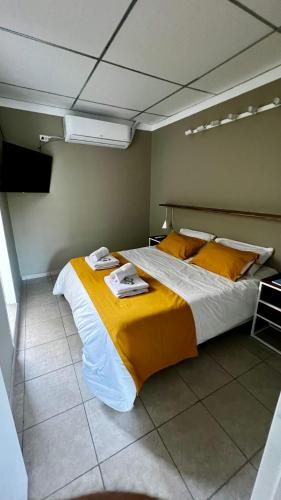 a bedroom with a large bed with yellow sheets at Alquiler Temporario Perico 1 in Perico