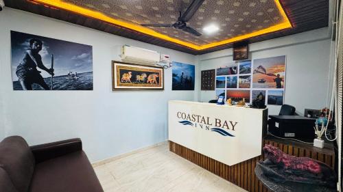 a waiting room with a coastel bay sign on a wall at Coastal Bay Inn by Green Apple Stays in Alibaug