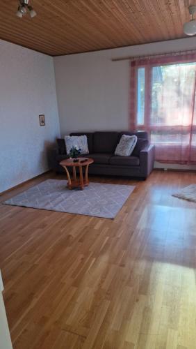 a living room with a couch and a table at Kodikas koti in Lapua