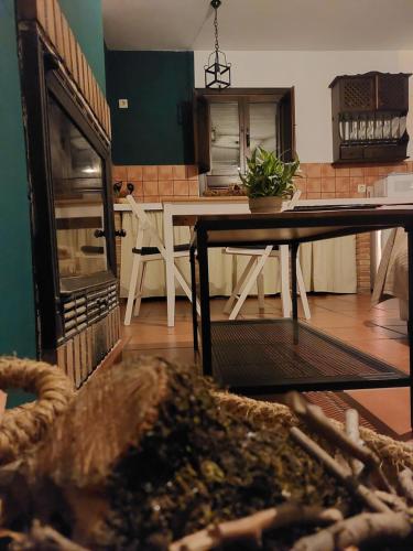 a kitchen with a table and a dining room at Apartamento Rural Las Palmeras in Almonaster la Real