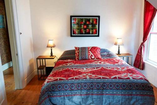 a bedroom with a bed and two tables with lamps at Downtown Picton, salt water pool in Picton