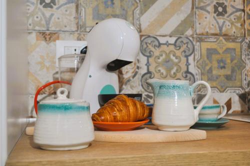 a counter with a mixer and a plate of croissants at Casa Teresa in Portoscuso