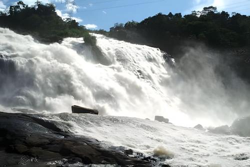 a large waterfall in the middle of a river at Residencial GO 305 - in Poços de Caldas