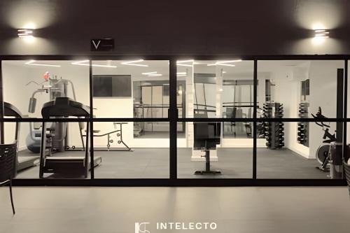 a view of a gym through a glass window at Residencial GO 305 - in Poços de Caldas