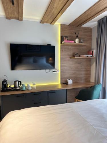 a bedroom with a bed and a tv on a wall at Apartments D242 & D243 in Aparthotel Vucko in Jahorina