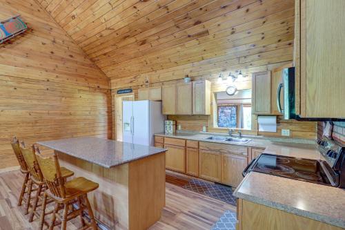 a kitchen with wooden cabinets and a white refrigerator at Secluded Harrison Retreat Near Buffalo Natl River in Harrison