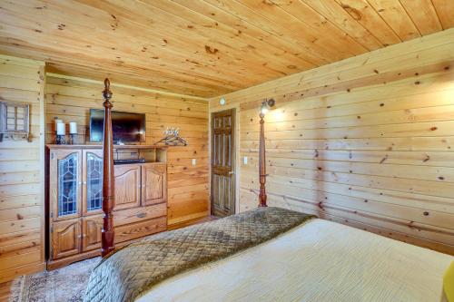 a bedroom with a bed in a log cabin at Secluded Harrison Retreat Near Buffalo Natl River in Harrison