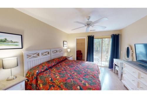 a bedroom with a bed and a flat screen tv at Litchfield Beach & Golf Resort in Pawleys Island