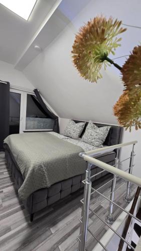 a bedroom with a bed and some plants on the wall at E+E Apartment Nah am Centro in Oberhausen