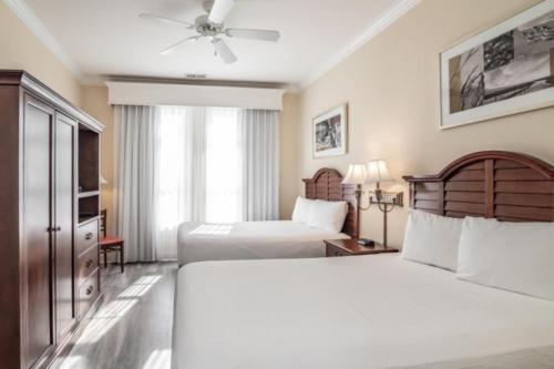 a hotel room with two beds and a ceiling fan at Litchfield Beach & Golf Resort in Pawleys Island