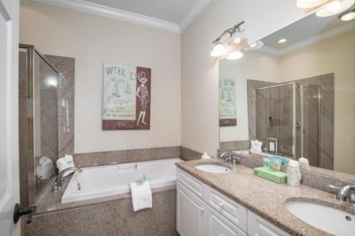 a bathroom with two sinks and a bath tub at Litchfield Beach & Golf Resort in Pawleys Island