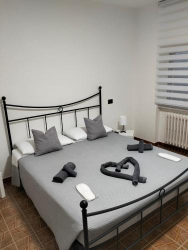 a bedroom with a large bed with slippers on it at La Casa dei Ricordi in Toro
