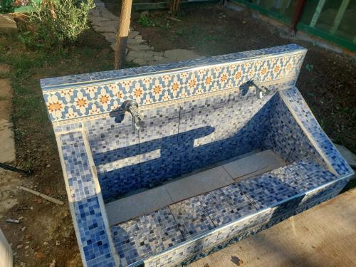 a mosaic sink with two faucets in a yard at Chez le fermier Ferme pédagogique in Tetouan