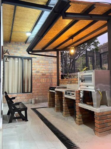 a patio with a grill and a table and a chair at Casa Tinta & hierro in Naranjo