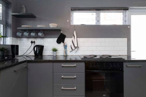 a kitchen with a stove and a counter top at Simple Studio in Sea Point in Cape Town