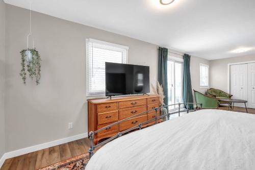 a bedroom with a bed and a television on a dresser at Cozy 4 Bedroom Home in Cornwall in Cornwall