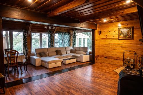 a living room with a couch and a table at Dom Parlinek agroturtstyka wędkowanie sauna jacuzzi in Dąbrowa