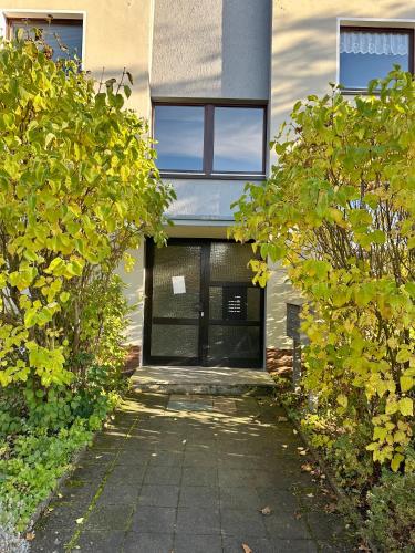 a building with a glass door on the side of it at Akram Appartement V - für erholsame Ferien in Hildesheim