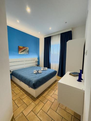 a bedroom with a bed with glasses on it at Casa Vacanze Il Vigneto in Marsala