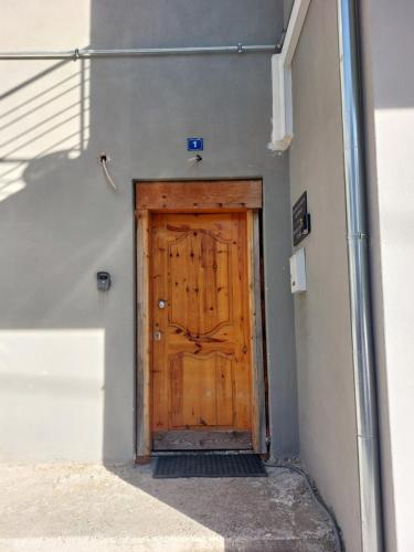 a wooden door in the side of a building at Aquarium House in Kalabaka