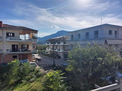 a group of buildings with mountains in the background at Aquarium House in Kalabaka