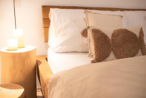 a bedroom with a bed with two pillows at Pálavský dům in Milovice
