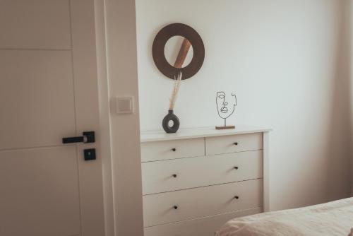 a bedroom with a dresser and a mirror on the wall at Pálavský dům in Milovice
