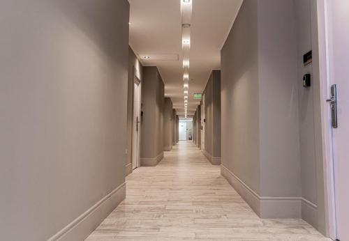 a corridor of an office building with a long hallway at RentUp Suites Salta in Salta