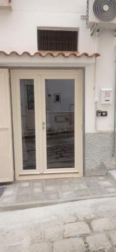 a door to a building with a window at Casa della Nonna in Montalbano Jonico