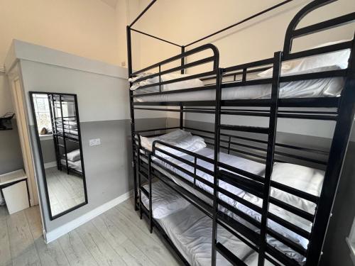a room with two bunk beds and a mirror at Haymarket Hostel in Edinburgh