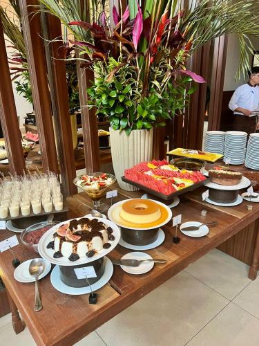 a table full of food and desserts on a table at Lindo Flat Particular em Moema em incrível Hotel administrado por gestora americana in Sao Paulo
