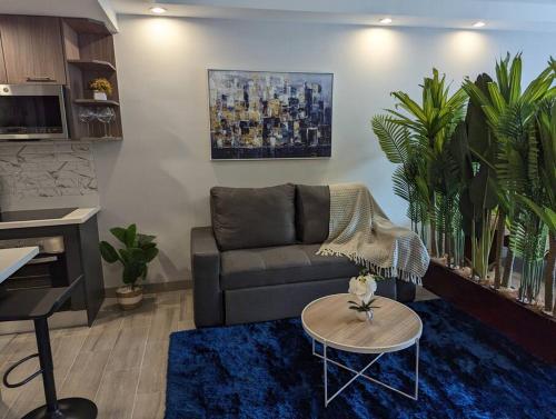 a living room with a couch and a table at 113 Rocks in Heredia