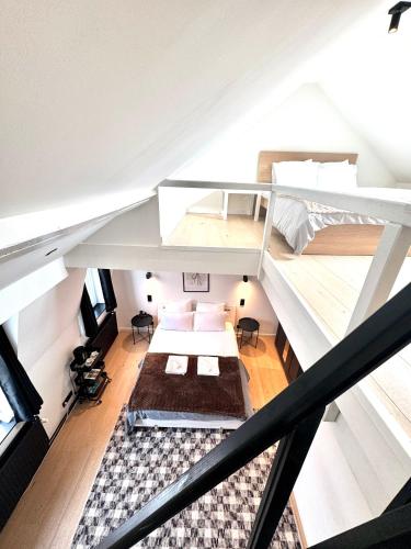 an attic bedroom with two bunk beds and a staircase at My Haus European Commision in Brussels