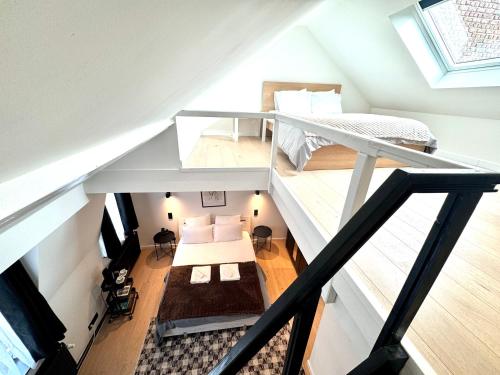 an attic bedroom with a bunk bed and a bunk bed at My Haus European Commision in Brussels