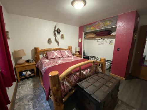 a bedroom with a bed with a wooden bed frame at Alaska's Point of View Full Suite in Seward
