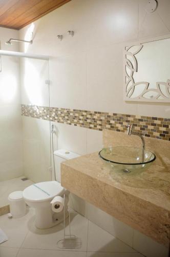 a bathroom with a sink and a toilet at Pousada Casa Mendes in Guapimirim