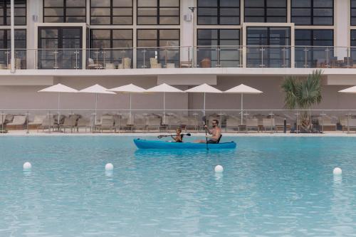 a couple of people in a boat in a pool at AVA Resort Cancun - All Inclusive in Cancún