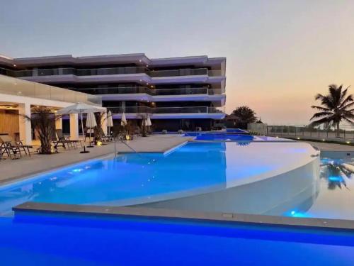 a swimming pool in front of a building at Elegant 2-Bed Rooms at Kololi Sands in Kololi