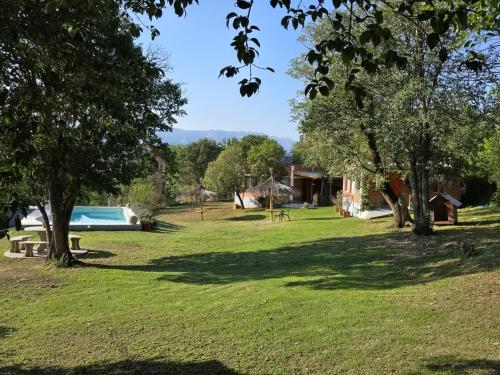 a park with a swimming pool and trees at Los Molles Suites -Solo 2 Pax- in Mina Clavero