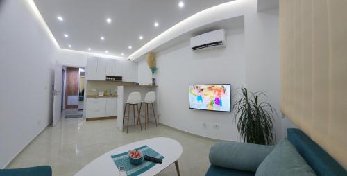 a living room with a couch and a table and a kitchen at A2 Apartment in Gostivar
