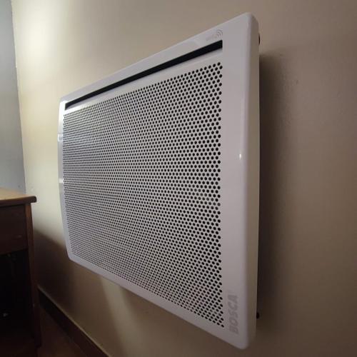 a white computer monitor hanging on a wall at Hostal Terraza Recreo in Viña del Mar