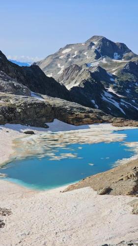 a mountain with a blue lake in front of it at Casa Belvedere in Gravere