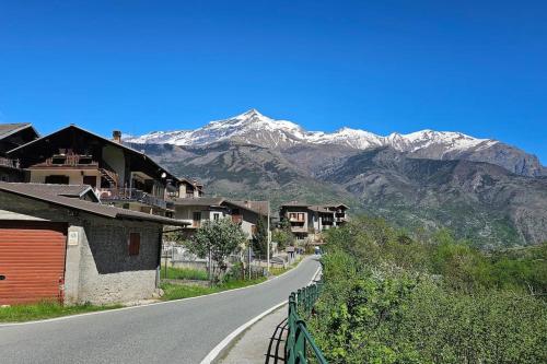 an empty road with snow capped mountains in the background at Casa Belvedere in Gravere