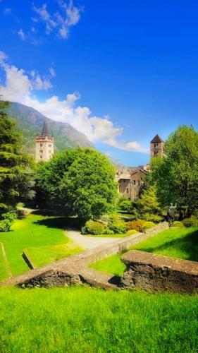 a view of a green field with buildings and trees at Casa Belvedere in Gravere