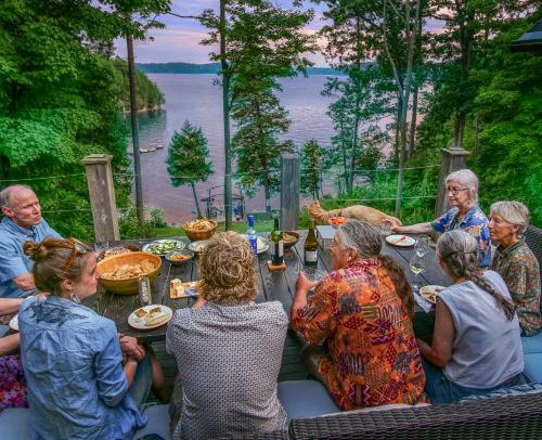 a group of people sitting around a table eating food at The Lakehouse of Braeloch in Colchester